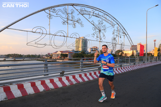Alejandro tạo d&aacute;ng khi chạy qua cầu Ninh Kiều. Ảnh: VnExpress Marathon